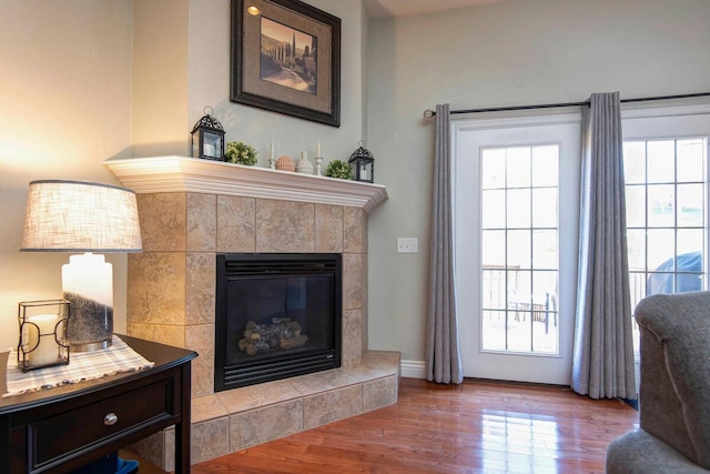707 E Mining Camp Rd, Nixa, MO 65714 - living room with a wealth of natural light, a tile fireplace, wood finished floors, and baseboards