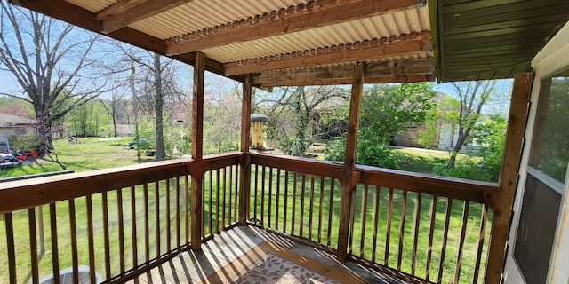 wooden deck featuring a lawn