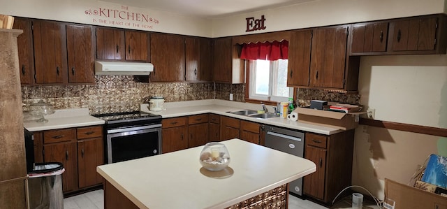kitchen featuring tasteful backsplash, appliances with stainless steel finishes, under cabinet range hood, light countertops, and a sink