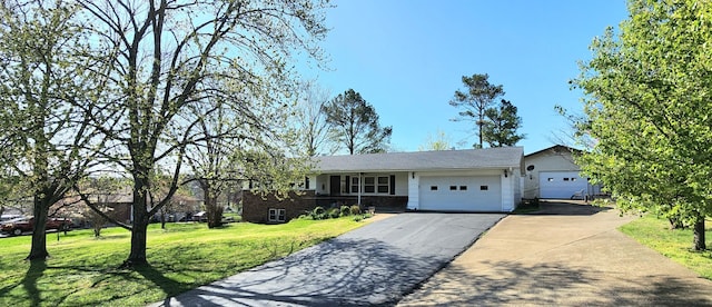 single story home with a front lawn, driveway, and an attached garage