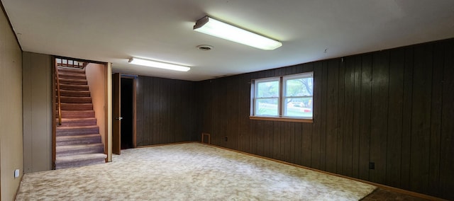 basement with wooden walls and stairs