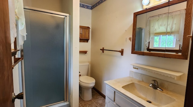 bathroom featuring toilet, a stall shower, tile patterned floors, and vanity