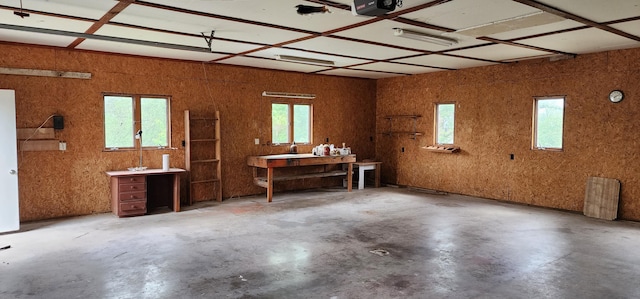 garage with a workshop area and a garage door opener