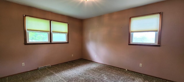 empty room with carpet and visible vents