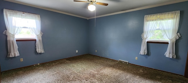 carpeted empty room featuring ceiling fan, crown molding, and visible vents