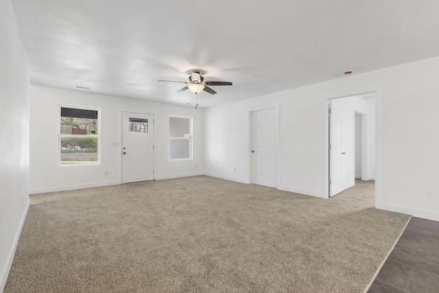 341 N Golden Ave, Springfield, MO 65802 - unfurnished living room with baseboards, a ceiling fan, and carpet