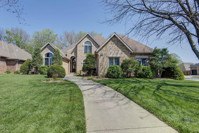 view of front of property with brick siding and a front lawn