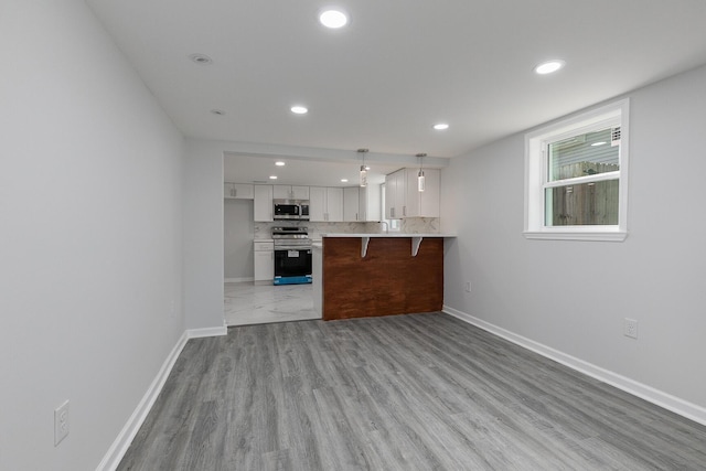 2120 N Broadway Ave, Springfield, MO 65803 - kitchen featuring stainless steel appliances, recessed lighting, white cabinetry, and baseboards