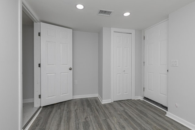 2120 N Broadway Ave, Springfield, MO 65803 - unfurnished bedroom with a closet, baseboards, recessed lighting, visible vents, and wood finished floors