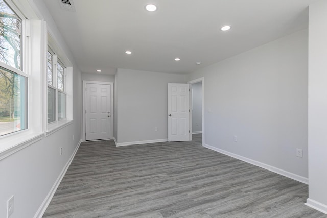 2120 N Broadway Ave, Springfield, MO 65803 - empty room with wood finished floors, visible vents, and recessed lighting