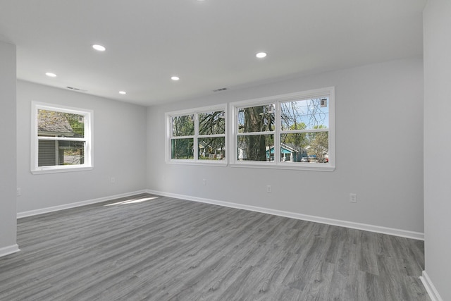 2120 N Broadway Ave, Springfield, MO 65803 - empty room with a healthy amount of sunlight, wood finished floors, baseboards, and recessed lighting