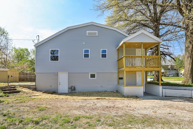 2120 N Broadway Ave, Springfield, MO 65803 - rear view of house featuring a storage unit, fence, and an outdoor structure