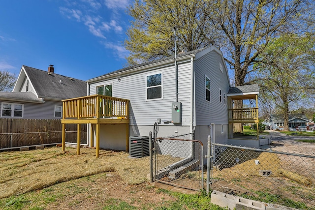 2120 N Broadway Ave, Springfield, MO 65803 - back of property with central AC unit, a deck, fence, and a gate