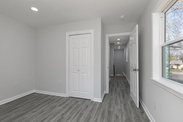 2120 N Broadway Ave, Springfield, MO 65803 - unfurnished bedroom featuring dark wood-style flooring, a closet, baseboards, and recessed lighting