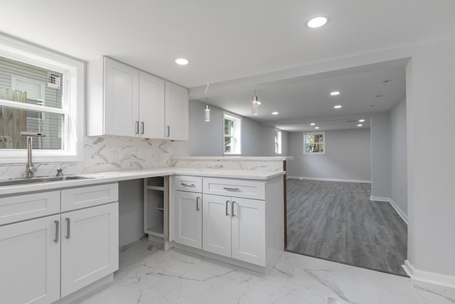 2120 N Broadway Ave, Springfield, MO 65803 - kitchen with tasteful backsplash, a sink, a peninsula, recessed lighting, and white cabinetry