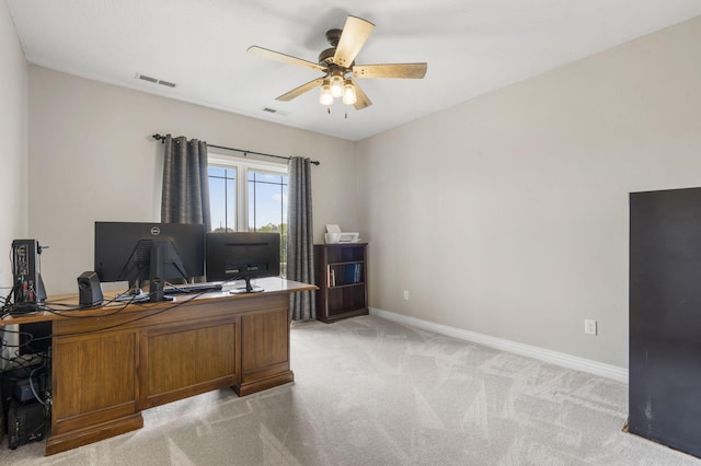 office featuring light carpet, baseboards, a ceiling fan, and visible vents