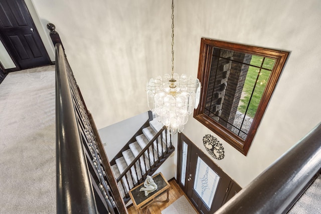 stairs featuring an inviting chandelier