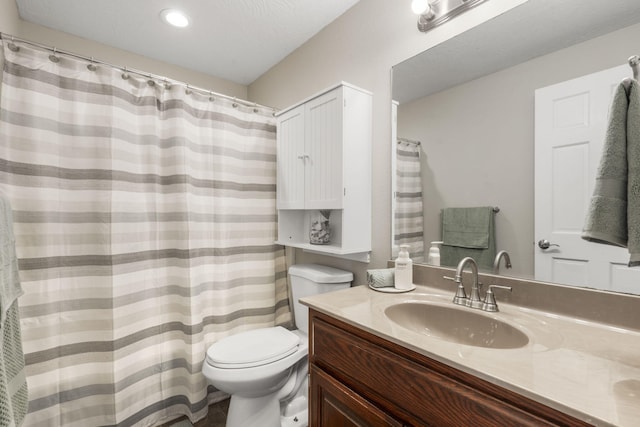 full bath featuring toilet, vanity, and recessed lighting