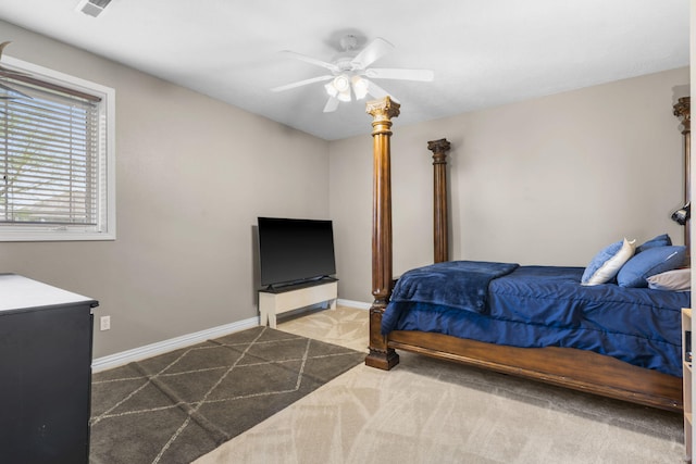 carpeted bedroom with visible vents, baseboards, and ceiling fan