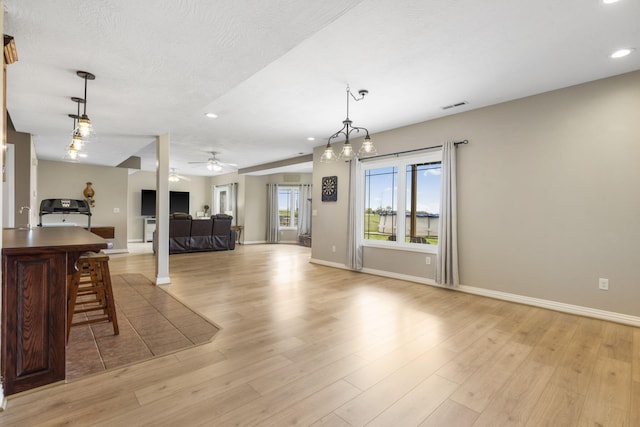 living room featuring recessed lighting, light wood-style flooring, baseboards, and ceiling fan