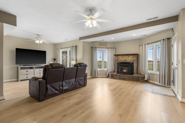living room with baseboards, recessed lighting, a ceiling fan, visible vents, and light wood finished floors