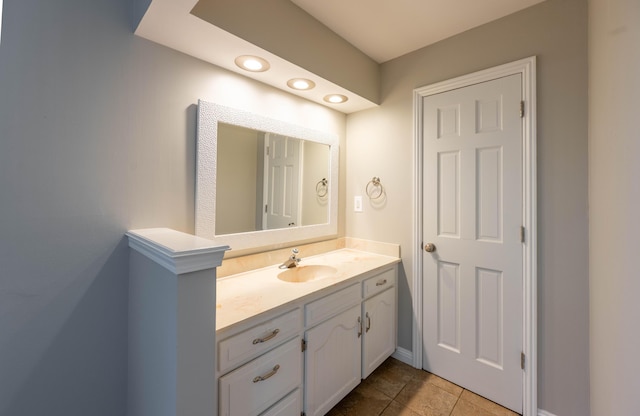 bathroom with baseboards, vanity, recessed lighting, and tile patterned floors