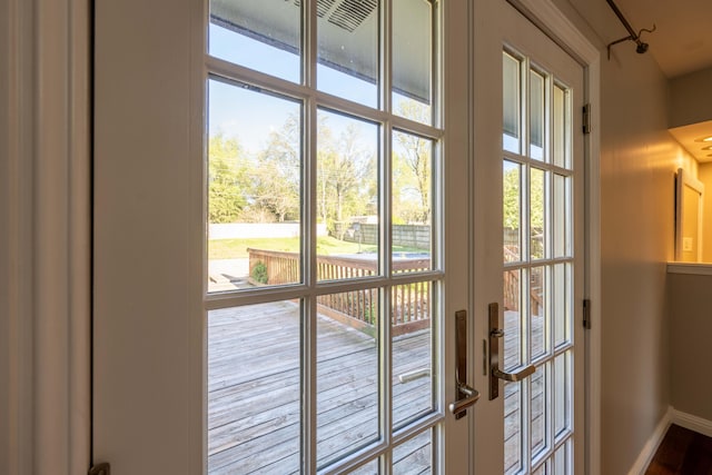 doorway to outside with baseboards
