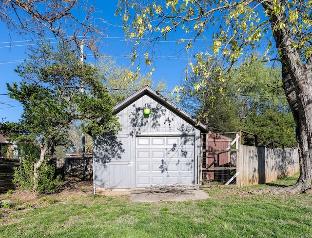 view of outbuilding with fence and an outbuilding