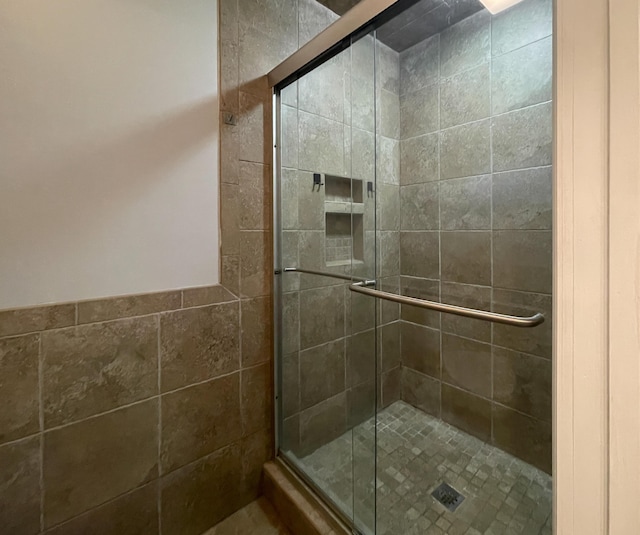 bathroom with a shower stall