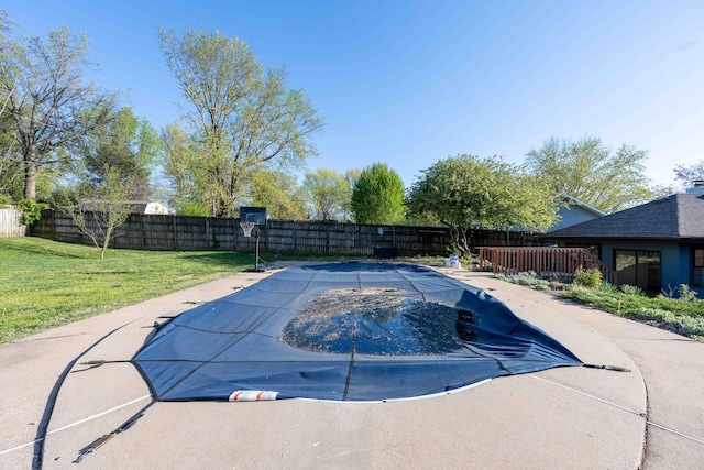 view of swimming pool with a lawn, a fenced backyard, and a fenced in pool