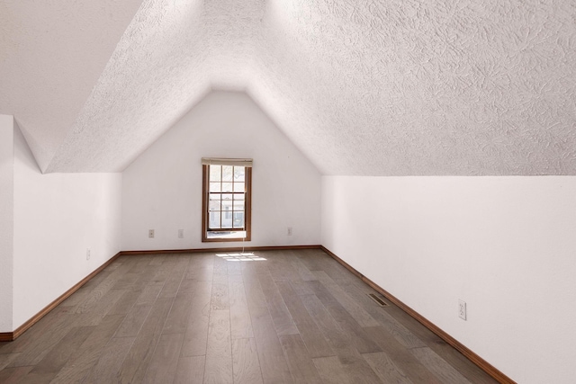 170 Oakridge Ave, Branson, MO 65616 - additional living space with a textured ceiling, wood finished floors, baseboards, and lofted ceiling
