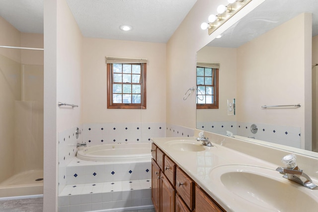 170 Oakridge Ave, Branson, MO 65616 - full bathroom featuring plenty of natural light, a garden tub, double vanity, a shower, and a textured ceiling