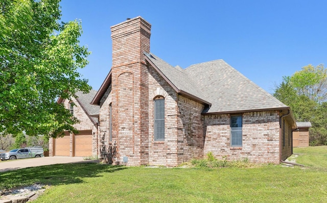 170 Oakridge Ave, Branson, MO 65616 - view of side of home featuring a chimney, driveway, a yard, brick siding, and a shingled roof
