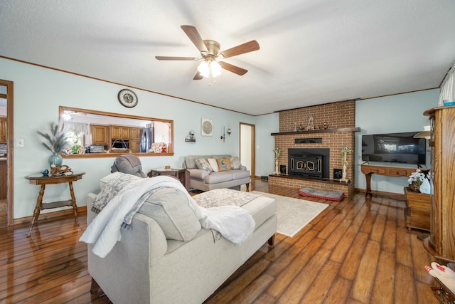 940 Industrial Dr, Neosho, MO 64850 - living room with a ceiling fan, wood-type flooring, a brick fireplace, crown molding, and baseboards