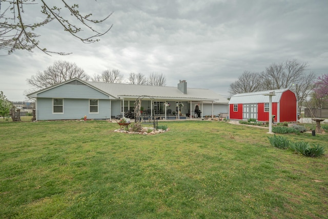 940 Industrial Dr, Neosho, MO 64850 - rear view of house featuring an outbuilding, a chimney, a lawn, and a patio