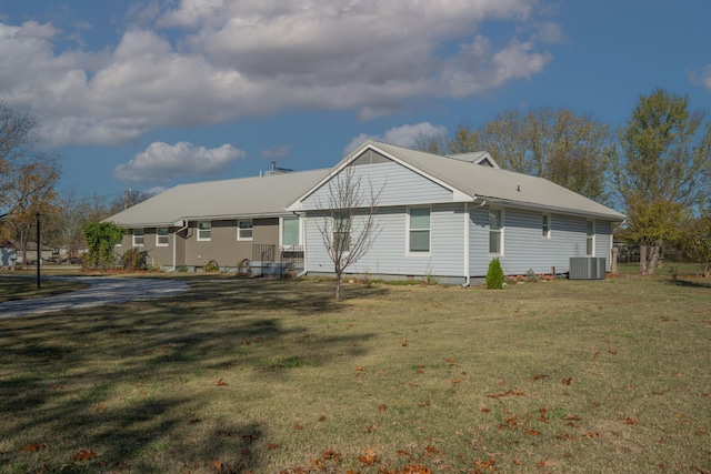 940 Industrial Dr, Neosho, MO 64850 - rear view of house featuring cooling unit, a yard, and metal roof