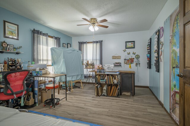 940 Industrial Dr, Neosho, MO 64850 - dining space with wood finished floors, a ceiling fan, a textured ceiling, and baseboards