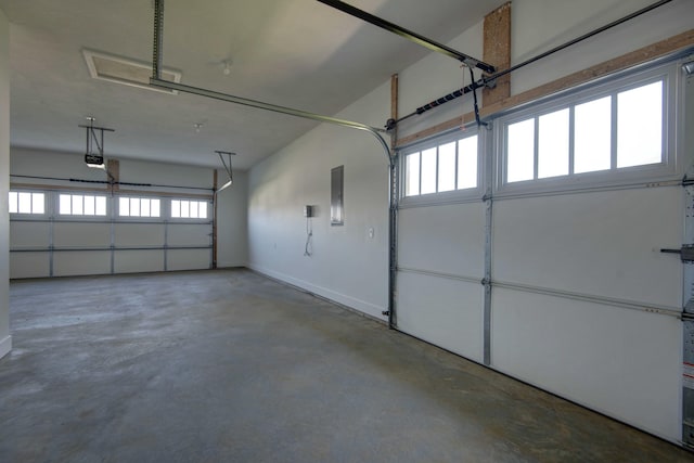 5896 Applewood Ave, Springfield, MO 65810 - garage featuring baseboards and a garage door opener