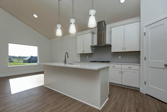 5896 Applewood Ave, Springfield, MO 65810 - kitchen featuring dark wood-style floors, backsplash, light countertops, gas cooktop, and wall chimney exhaust hood