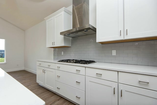 5896 Applewood Ave, Springfield, MO 65810 - kitchen featuring wall chimney range hood, stainless steel gas stovetop, light wood finished floors, light countertops, and white cabinets