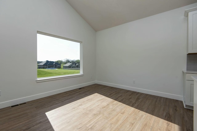 5896 Applewood Ave, Springfield, MO 65810 - empty room featuring baseboards, vaulted ceiling, visible vents, and dark wood finished floors