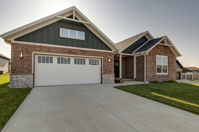 5896 Applewood Ave, Springfield, MO 65810 - craftsman-style house with a front lawn, concrete driveway, board and batten siding, brick siding, and a garage