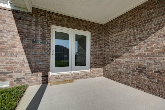 5896 Applewood Ave, Springfield, MO 65810 - property entrance with french doors, brick siding, and a patio