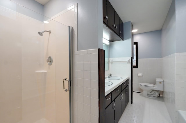 704 King St, Mount Vernon, MO 65712 - bathroom with tile patterned floors, a sink, a stall shower, tile walls, and toilet