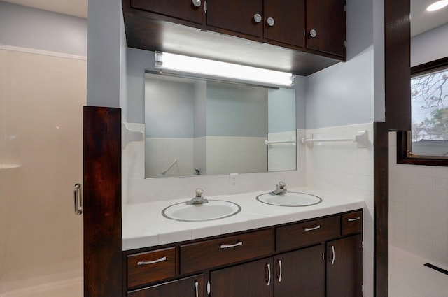 704 King St, Mount Vernon, MO 65712 - bathroom with decorative backsplash, a sink, double vanity, and a stall shower