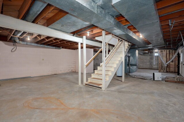 704 King St, Mount Vernon, MO 65712 - unfinished below grade area featuring heating unit and stairs