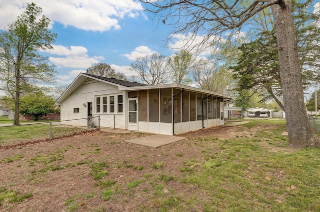 704 King St, Mount Vernon, MO 65712 - back of property featuring fence, a lawn, and a sunroom