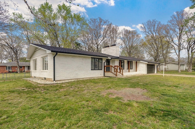 704 King St, Mount Vernon, MO 65712 - back of property featuring a chimney, fence, a yard, and a garage