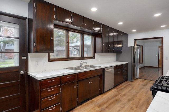 704 King St, Mount Vernon, MO 65712 - kitchen with recessed lighting, dark brown cabinets, a sink, light wood-style floors, and appliances with stainless steel finishes