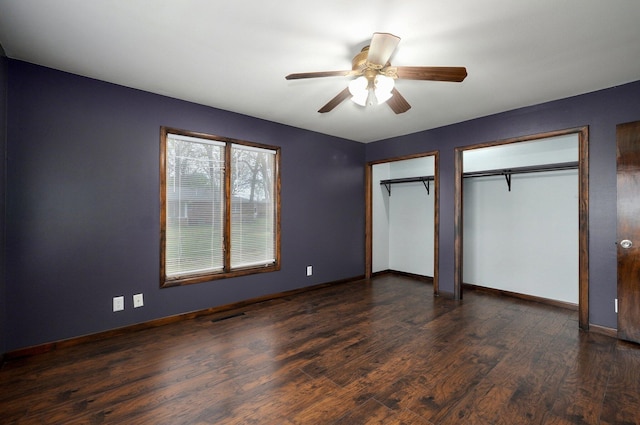 704 King St, Mount Vernon, MO 65712 - unfurnished bedroom featuring multiple closets, baseboards, and dark wood-style flooring